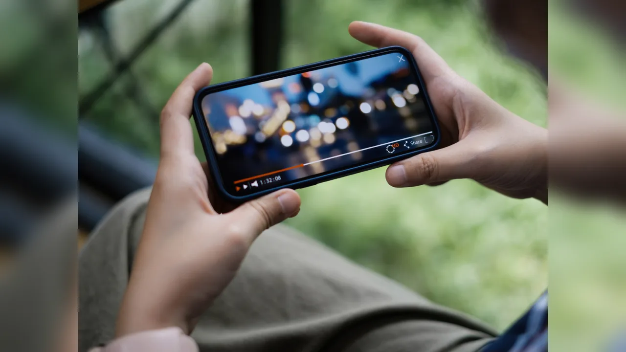 Two hands holding a phone in landscape watching a video