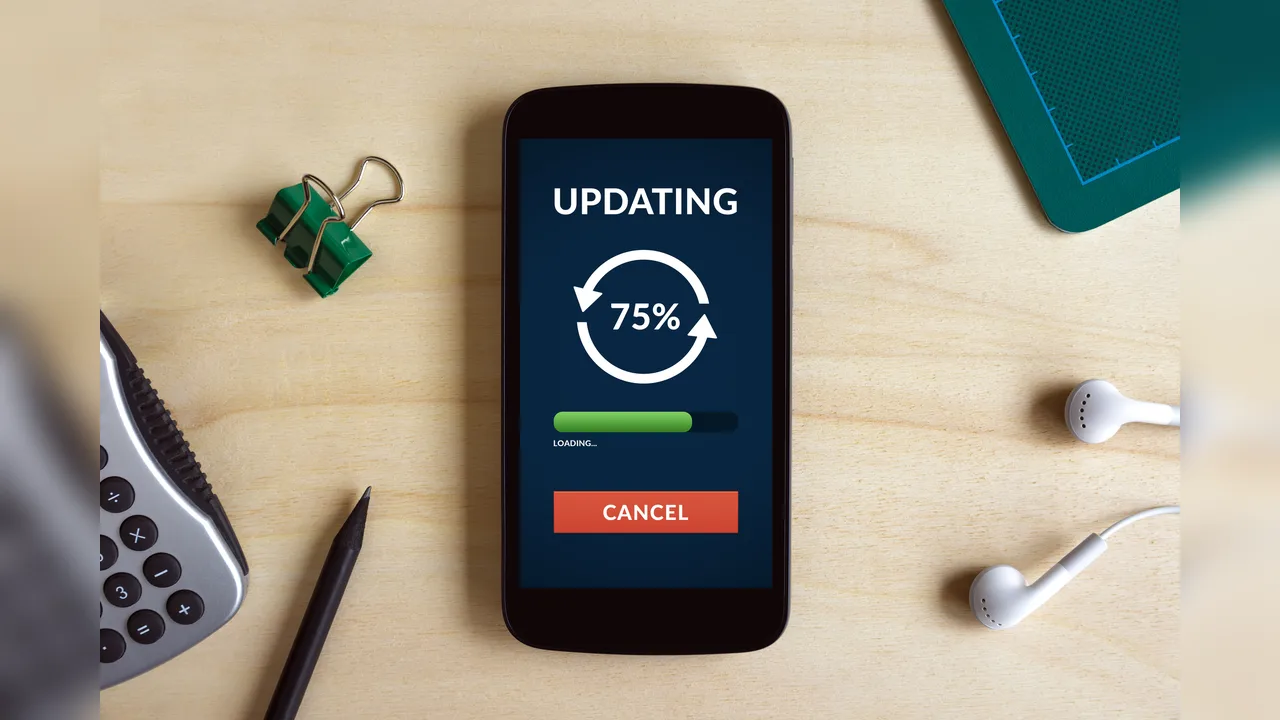 A phone on a desk showing an updating progress graphic